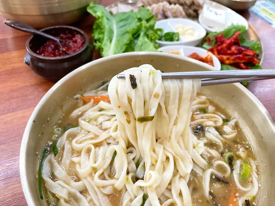 Close-up of the kalguksu broth and noodles
