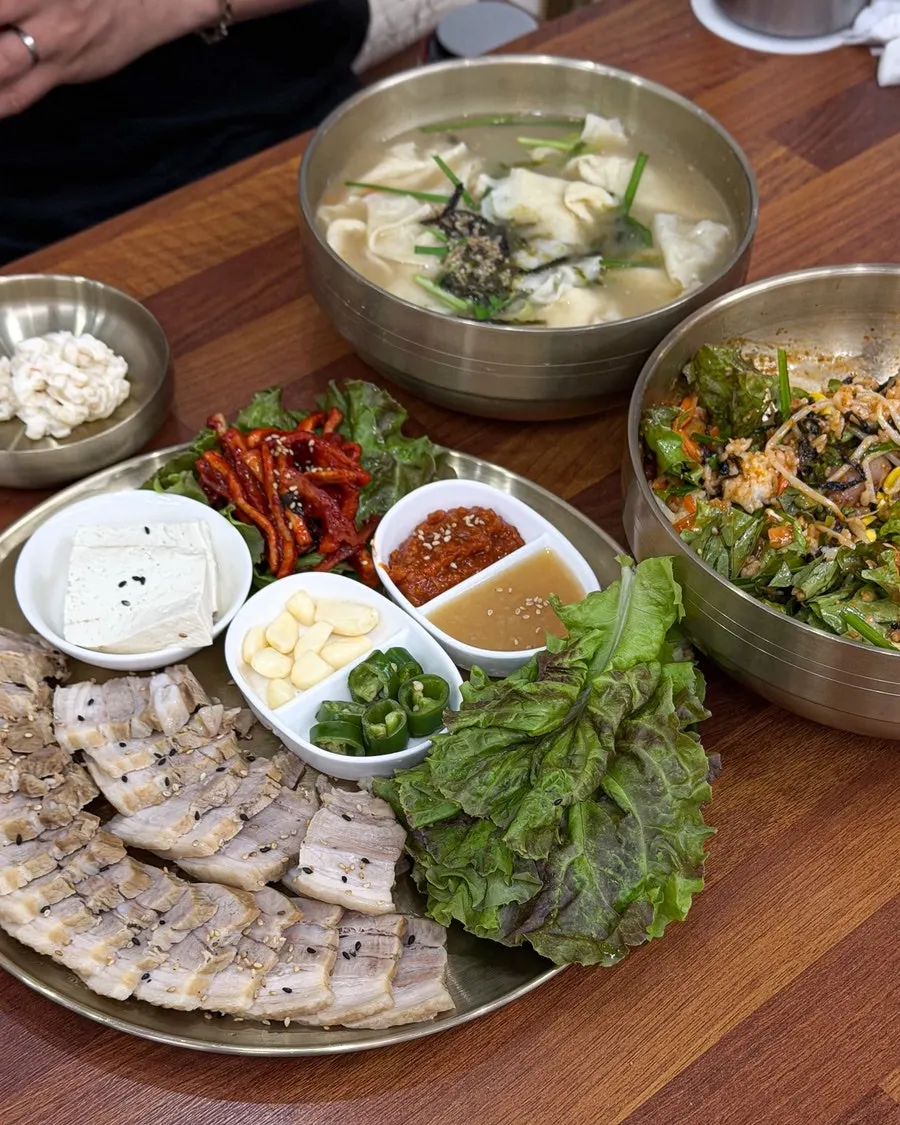 Full spread of sujebi, octopus bibimbap, and small bossam