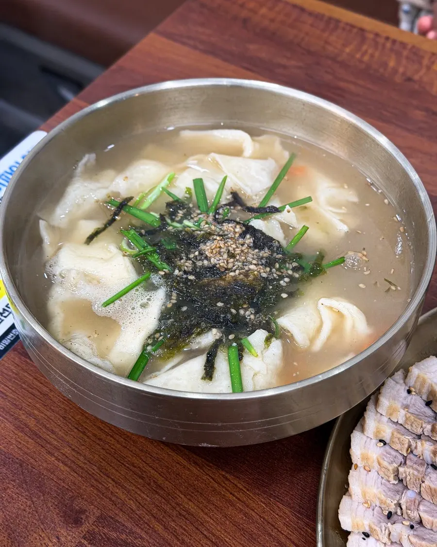 A bowl of unevenly sized hand-torn sujebi