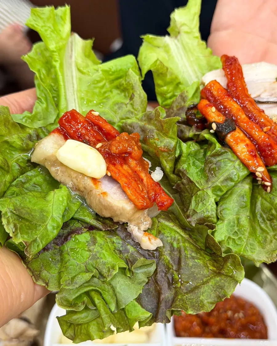 Bossam wrap topped with shredded kimchi