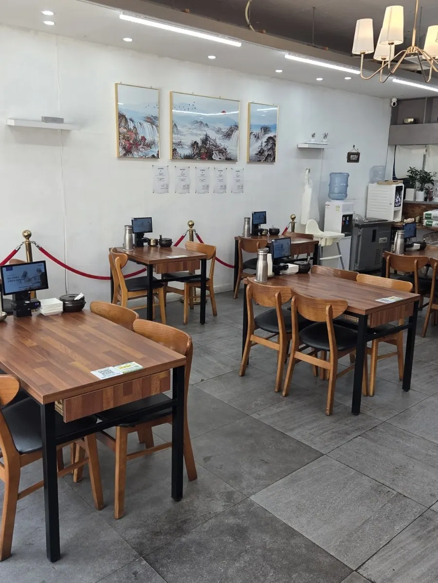 Interior of Sinseon Myeonga with white walls and wood tables