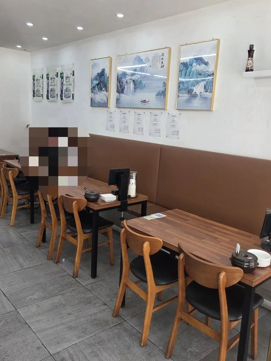 Dining hall with tables for two and four at Sinseon Myeonga