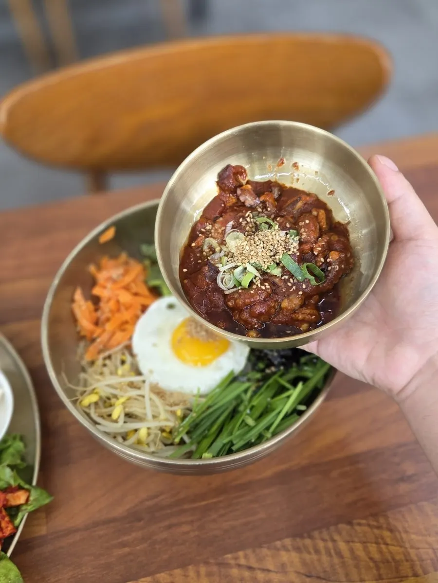 Octopus bibimbap with vegetables and a fried egg