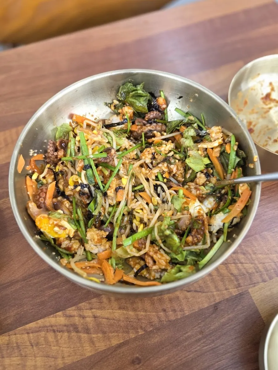 Bibimbap topped with separately served stir-fried octopus