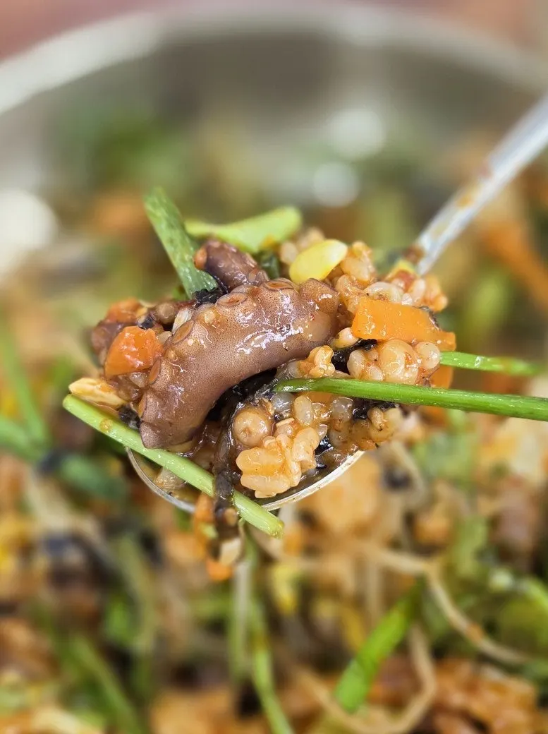 A bowl of octopus bibimbap after mixing