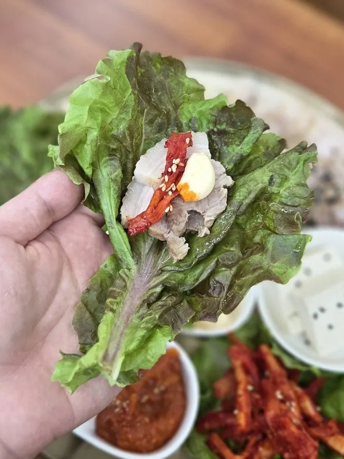 Lettuce wrap with bossam pork and dried radish strips