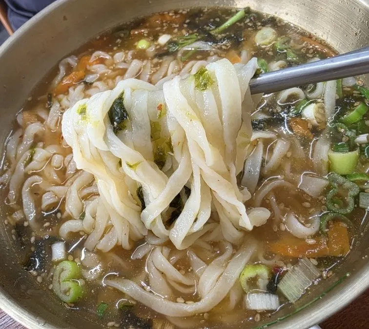 Anchovy kalguksu served with seasoning sauce on the side