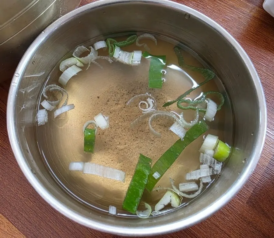 Clear soup served alongside the pork cutlet