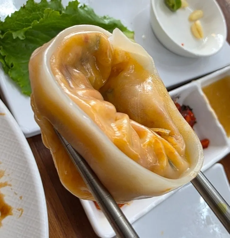 A dumpling split open to show the filling