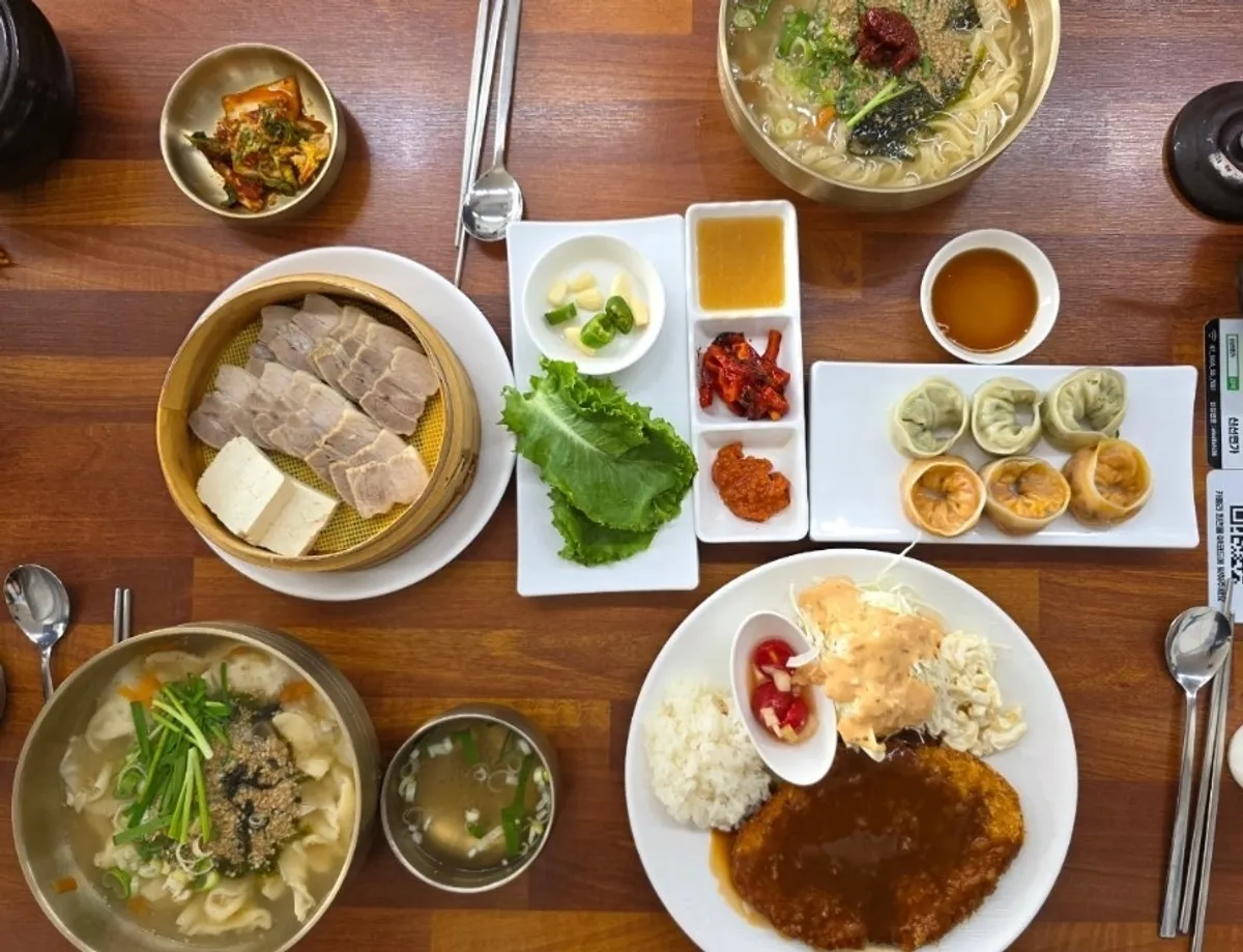 A full spread at Sinseon Myeonga with kalguksu, sujebi, bossam and pork cutlet