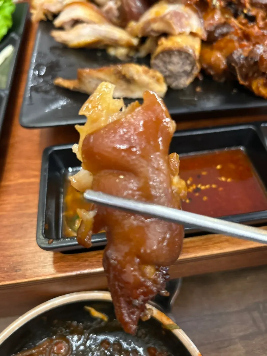 A bite of jokbal wrapped with radish salad