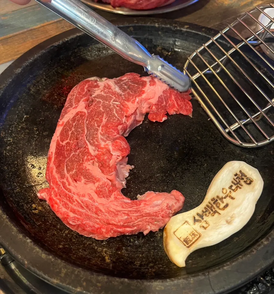 A bottle of Saero soju alongside the meat spread