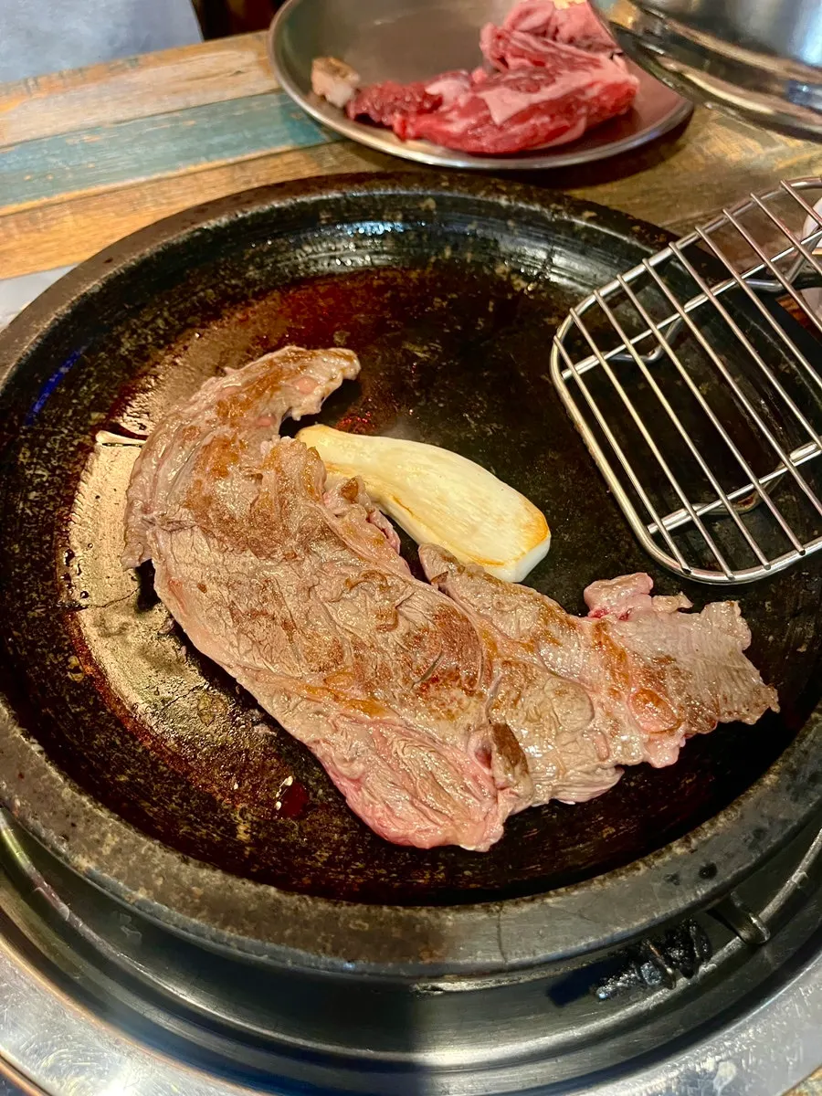 Hanwoo sirloin grilling on the preheated stone plate