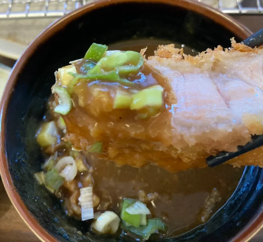 Tonkatsu dipped into curry