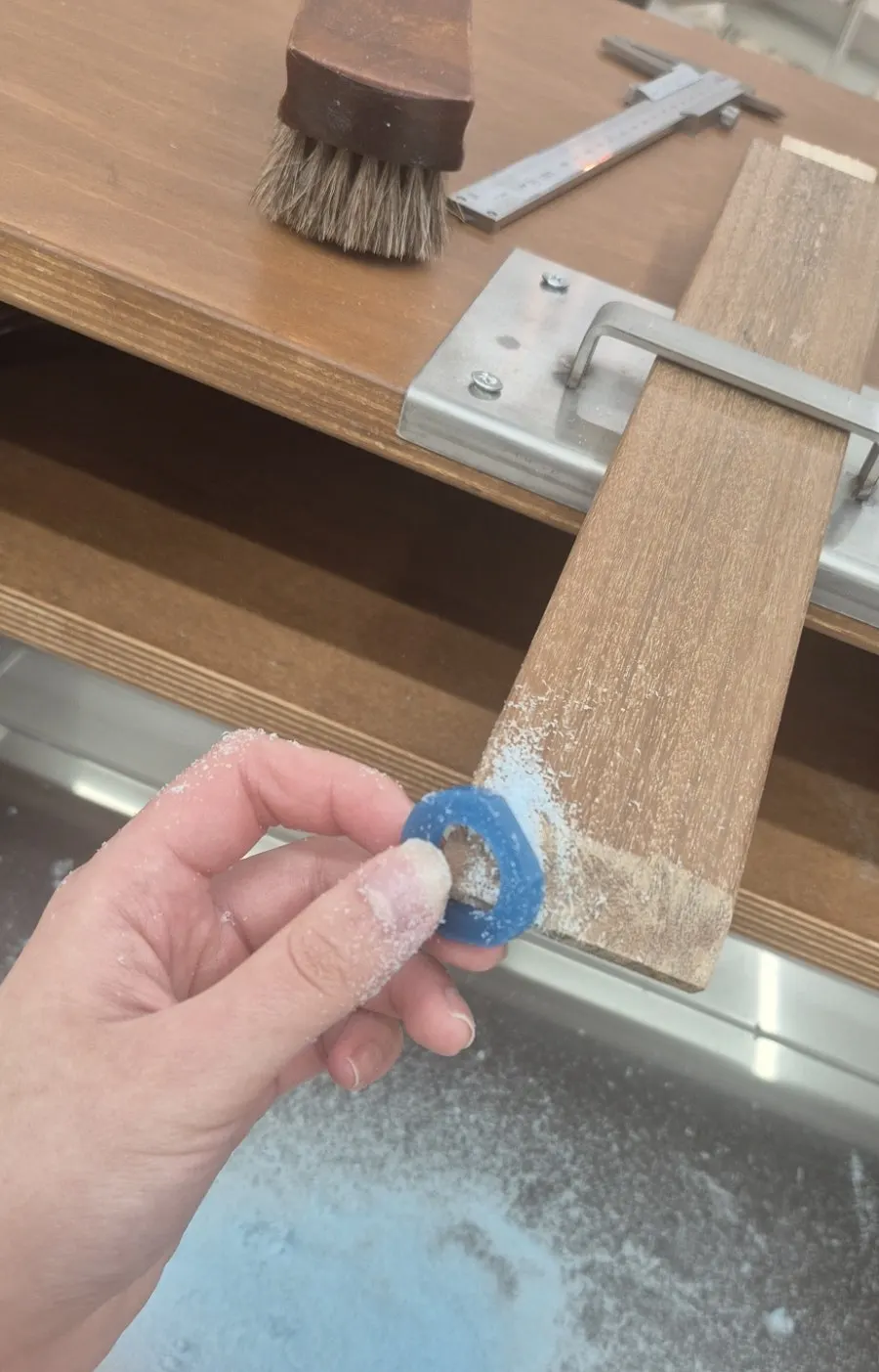 Carving wax with metal nippers during ring making