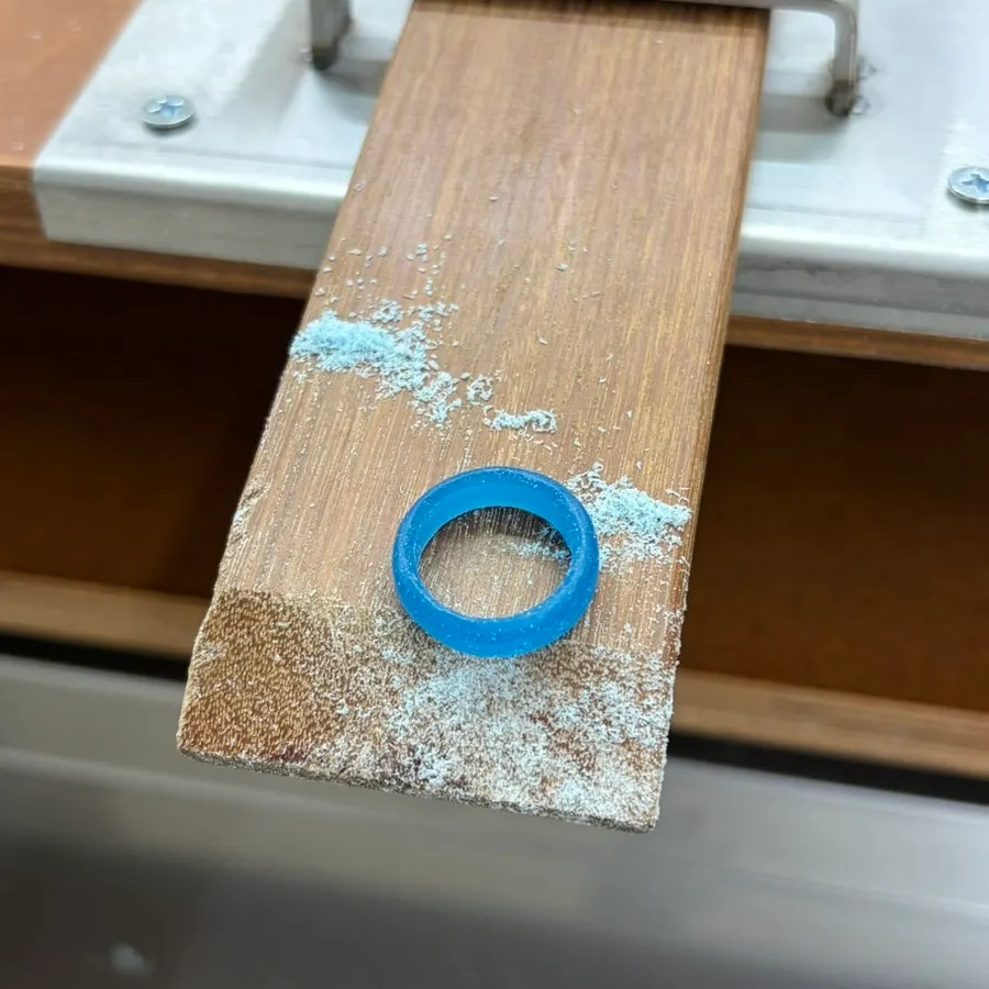 Hands making a ring covered with wax dust