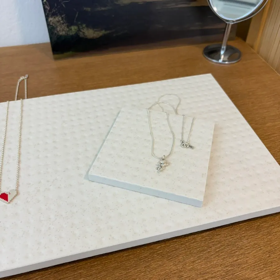 Silver jewelry pieces displayed in the workshop