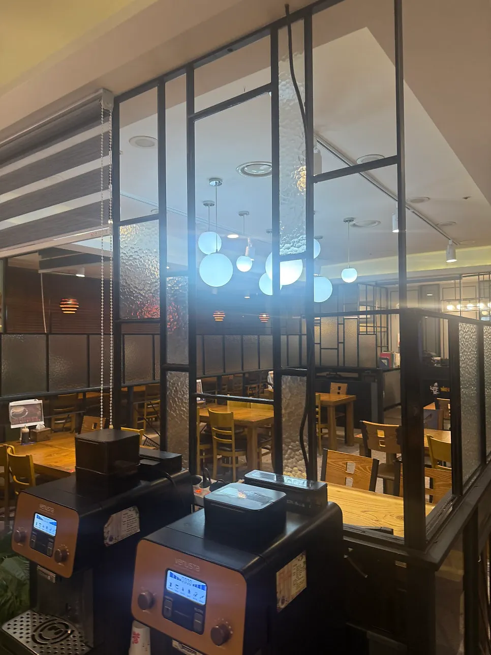 Restaurant interior with bright lighting and generous table spacing