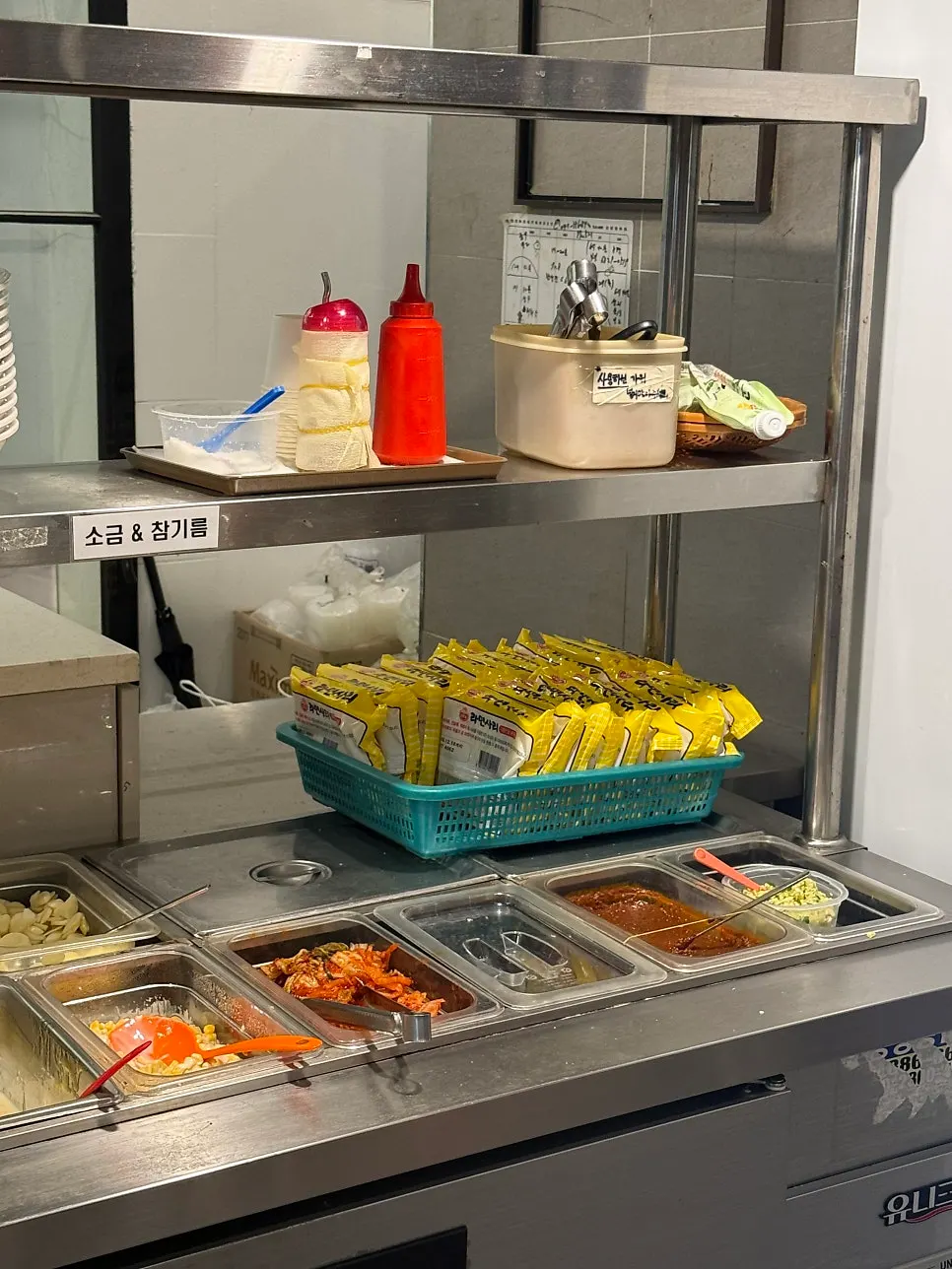 Various side dish containers at the self-serve bar