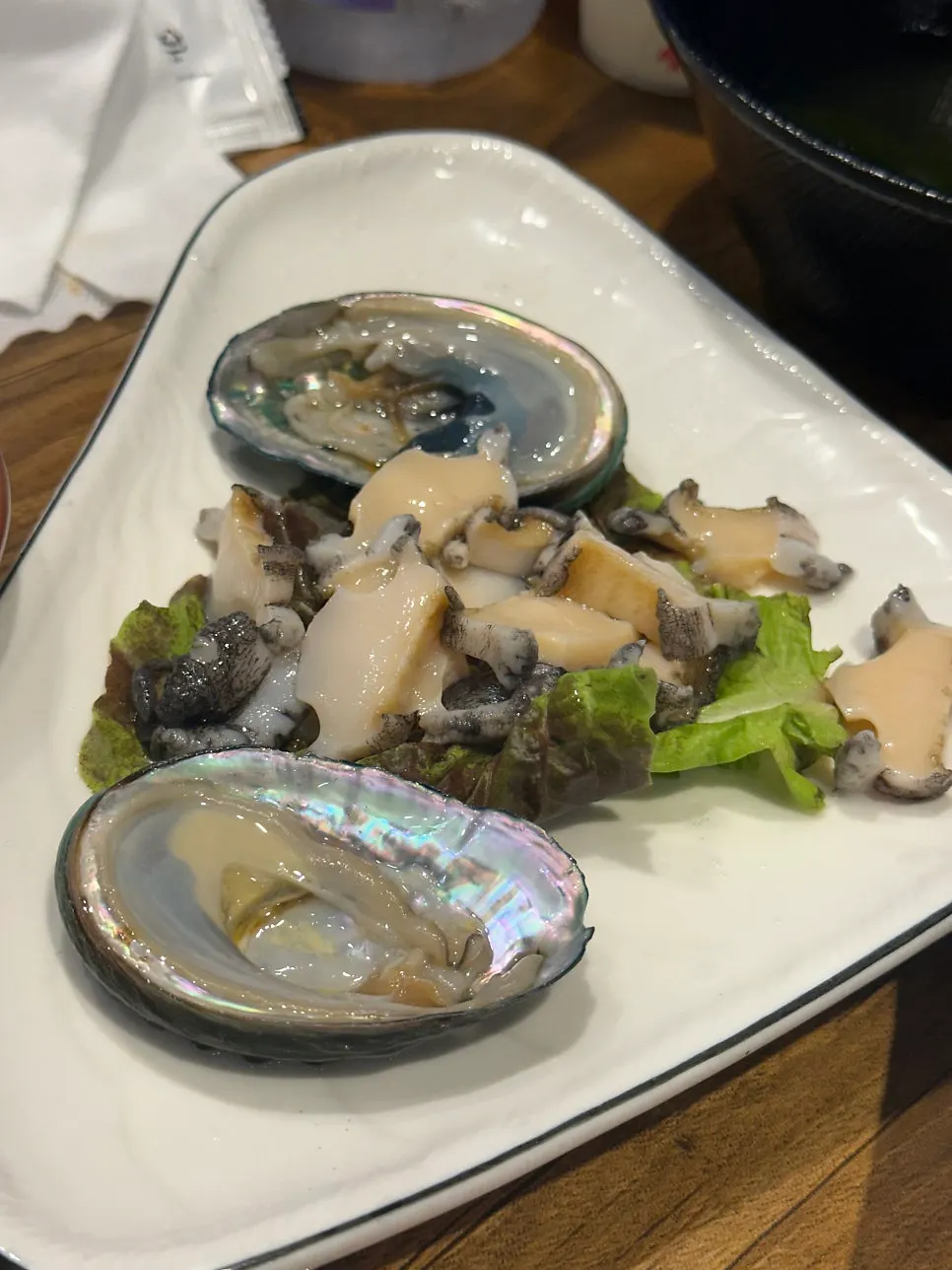 Two pieces of abalone sashimi received via the receipt review service