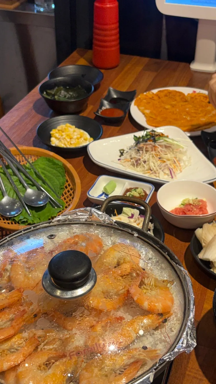 Plates of sashimi salad, pollack roe, and other side dishes