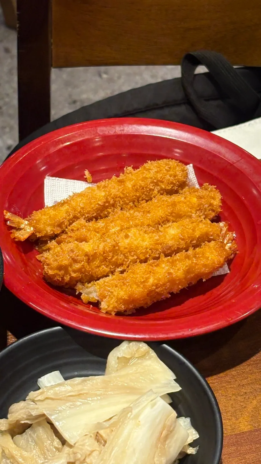 Golden grilled shrimp being peeled and eaten
