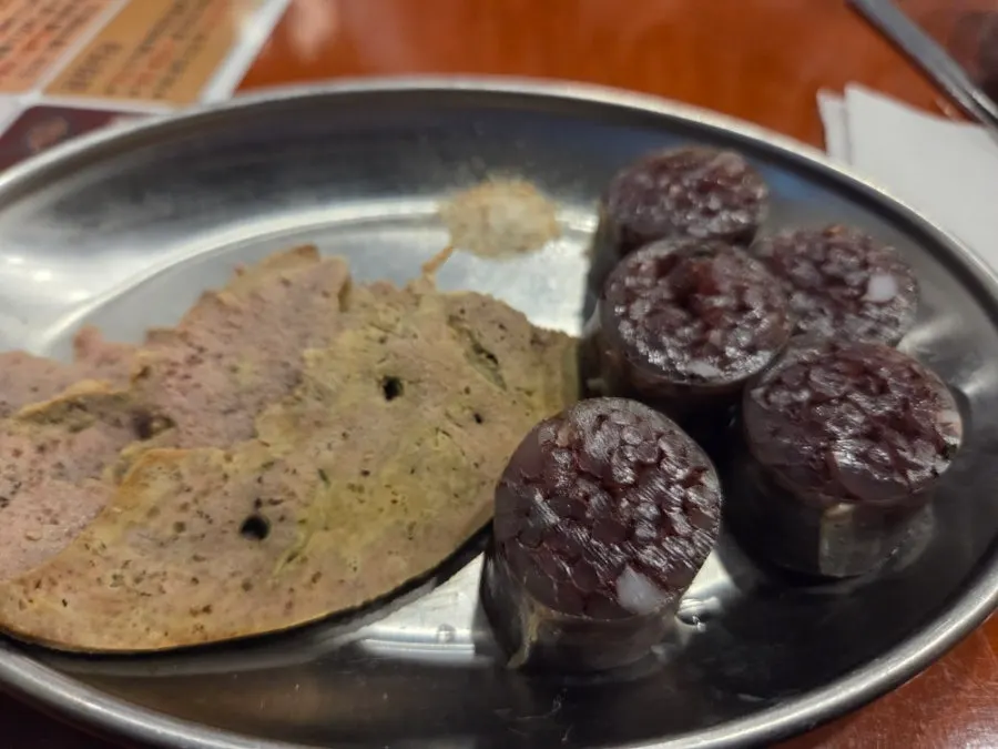 Fish cake skewers served in a yellow kettle
