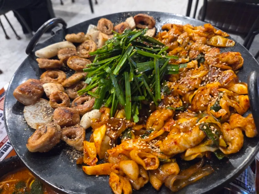 Salt-grilled makchang cooking on the grill