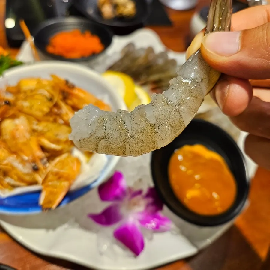 Raw shrimp sashimi dipped in buldak mayo and flying fish roe