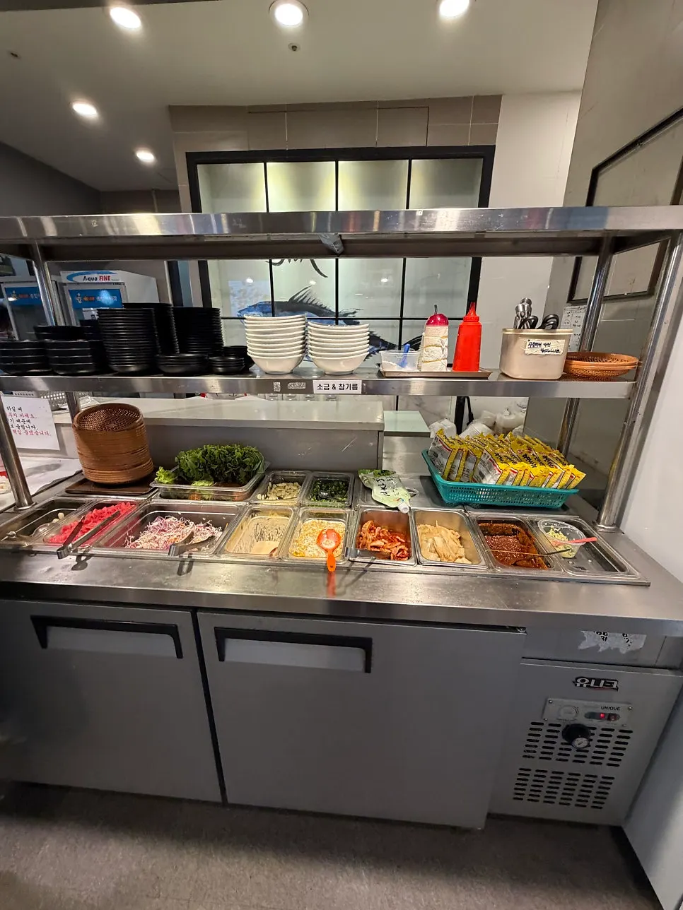Self-serve bar with vegetables and sauces