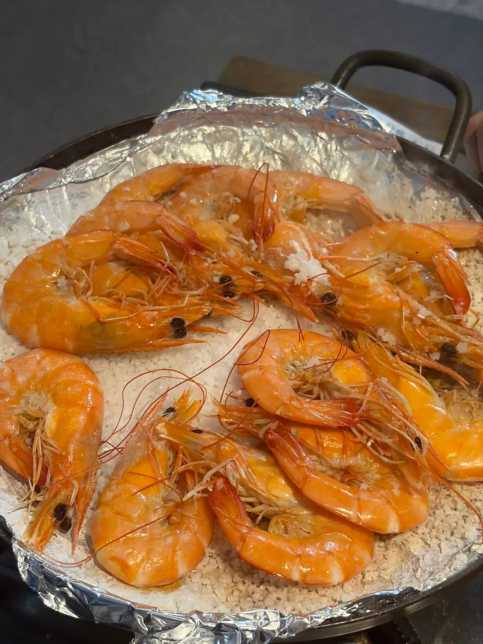 Peeled shrimp being dipped in vinegar-chili sauce