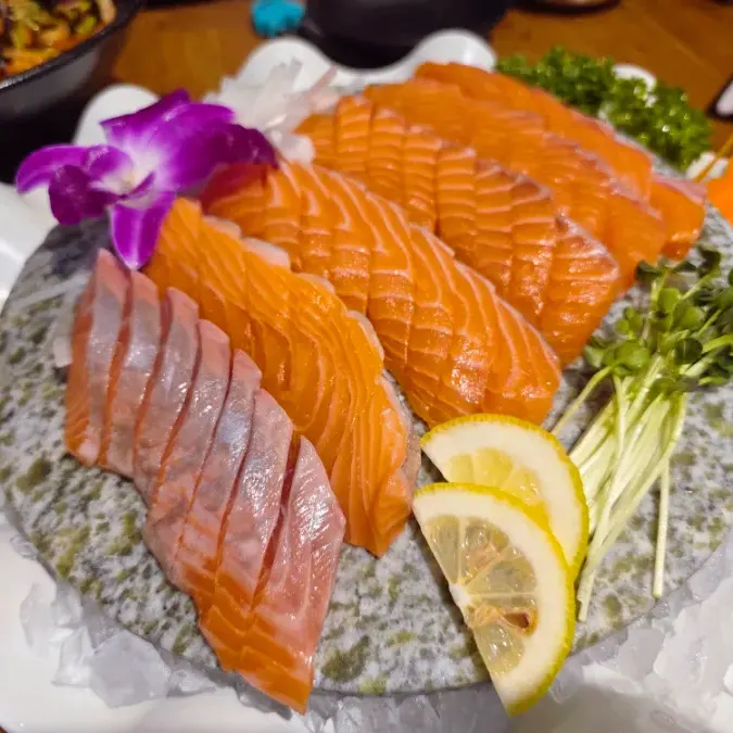 A seafood restaurant spread with salmon sashimi and mulhoe