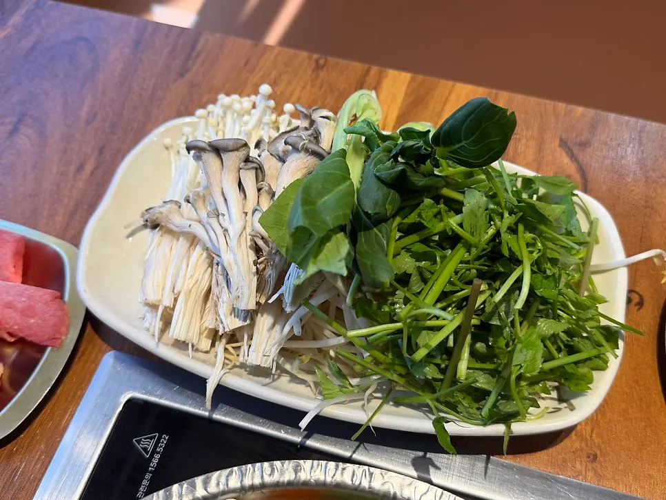 Vegetables being added to the boiling broth