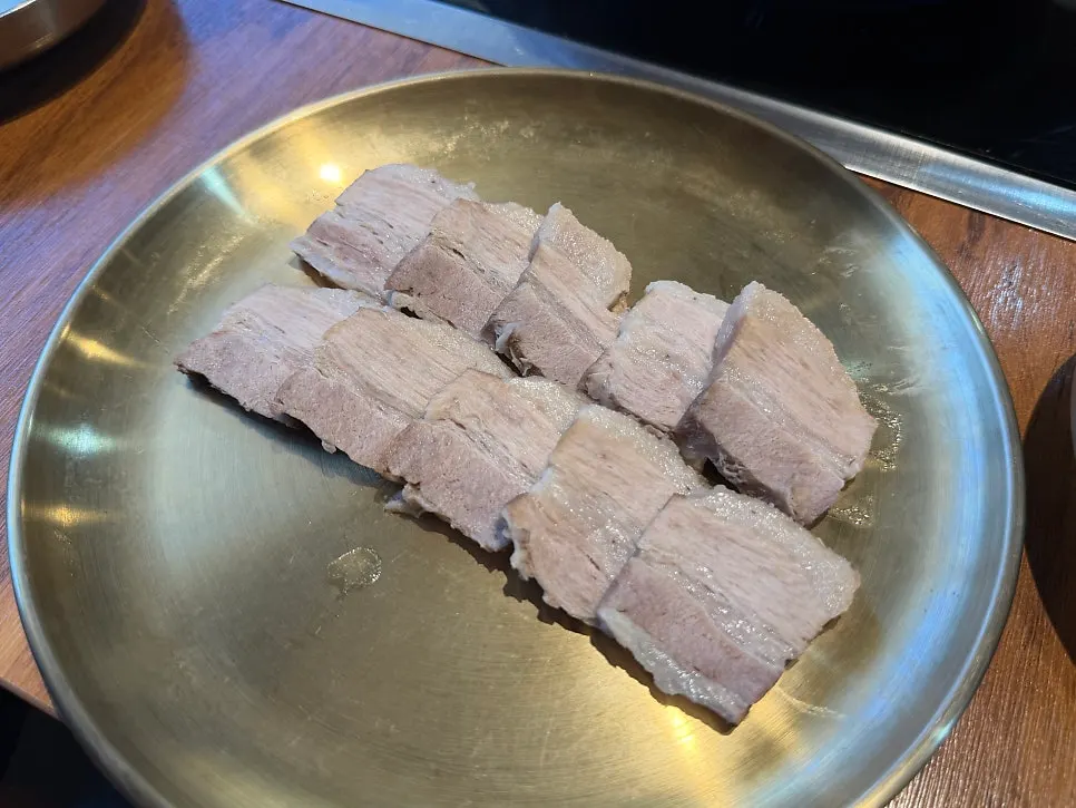 Thin slices of beef being cooked in the broth