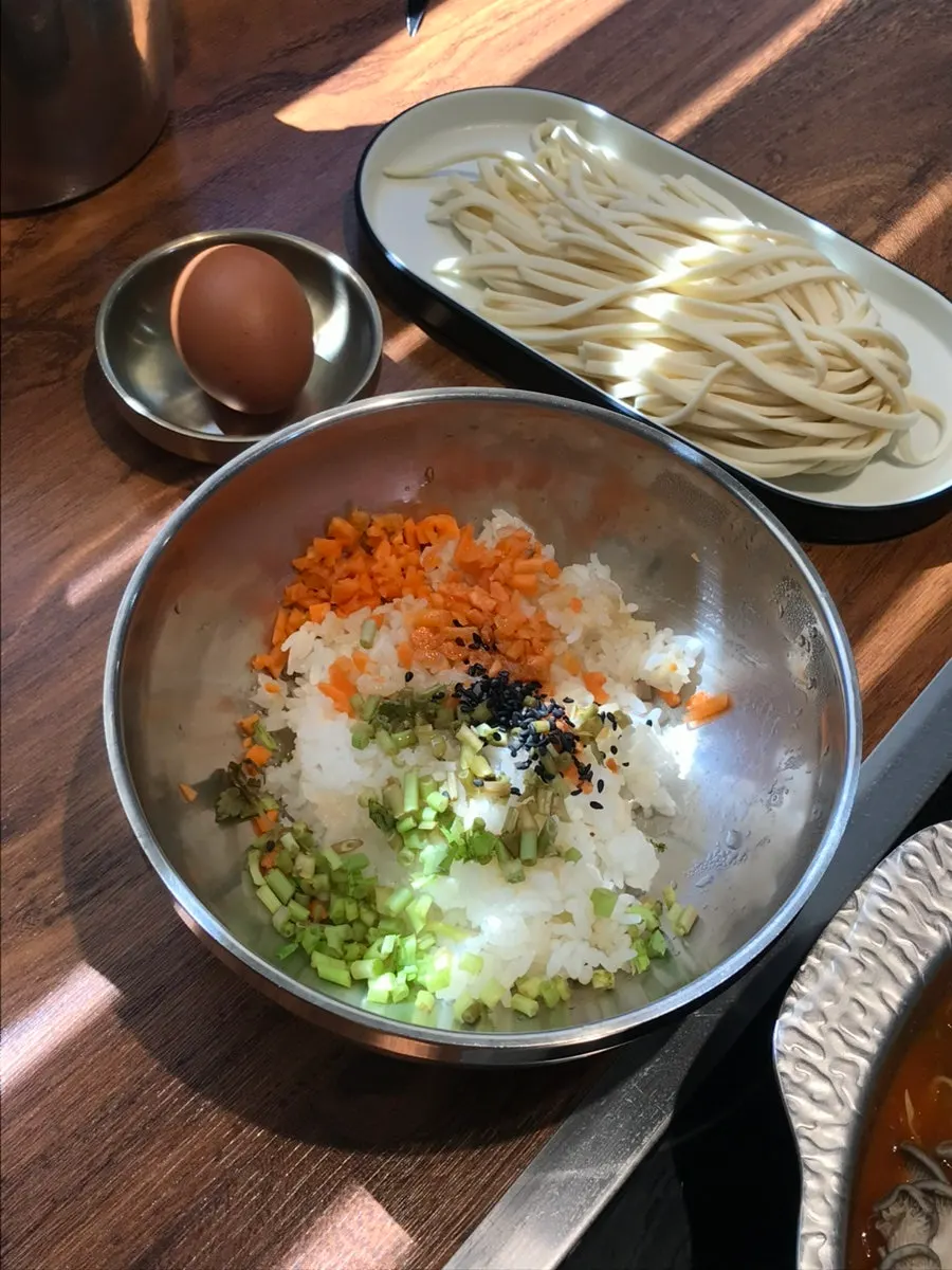 Egg, fried rice, and kalguksu noodles served alongside