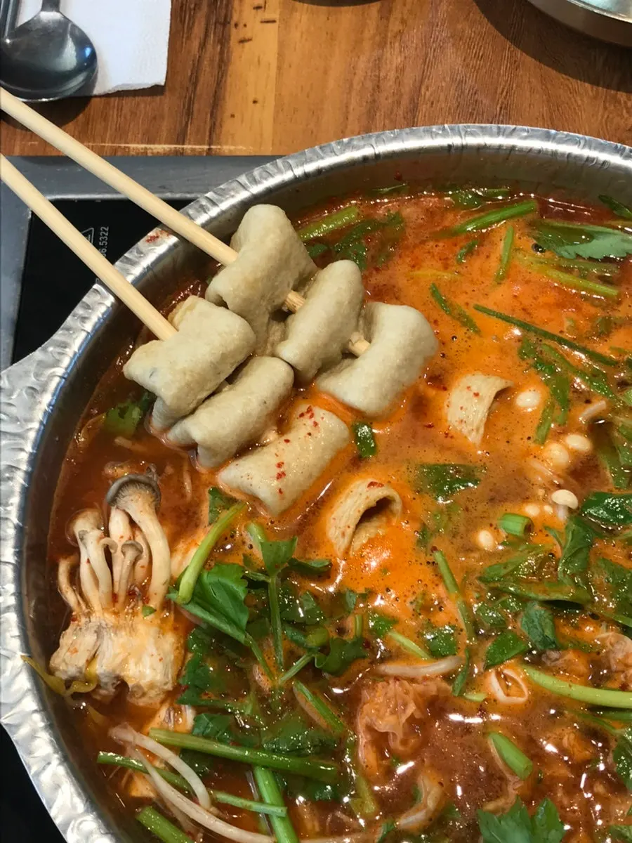 Cooked beef lifted out of the pot
