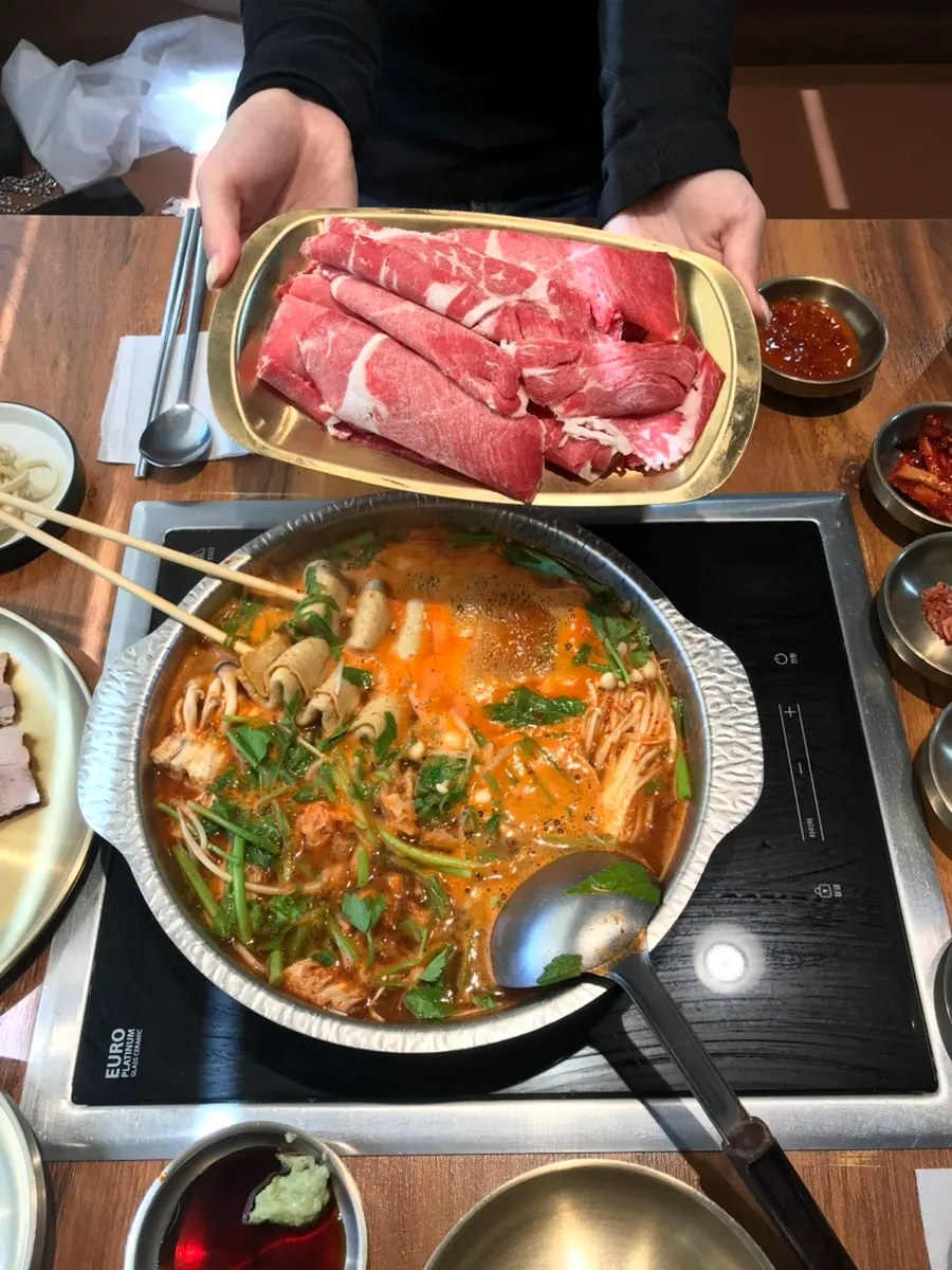 Fish cake added to the spicy shabu-shabu pot