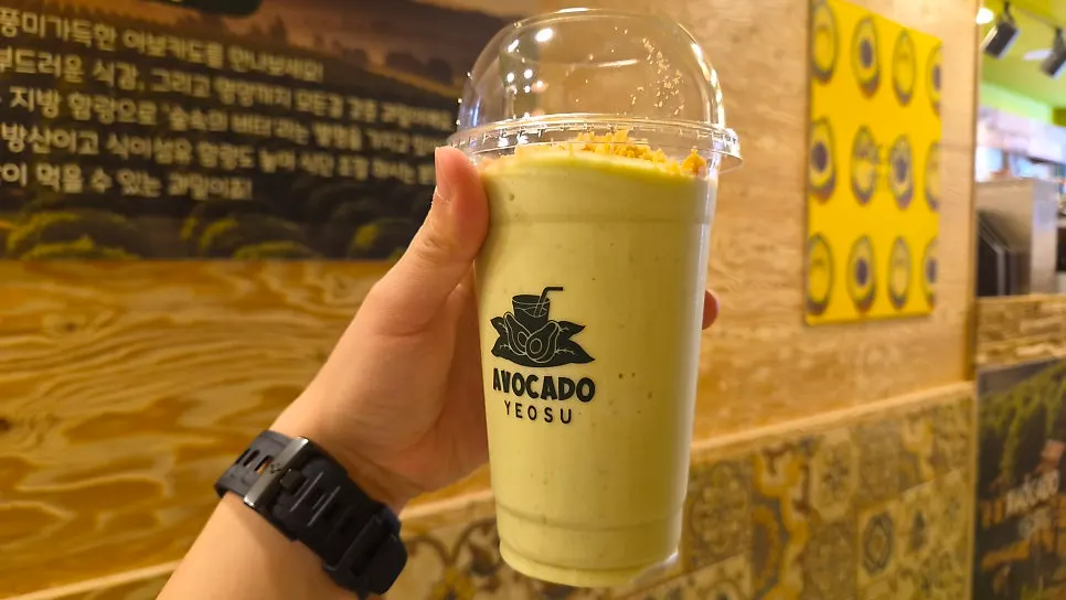 Glass of avocado smoothie after a sip