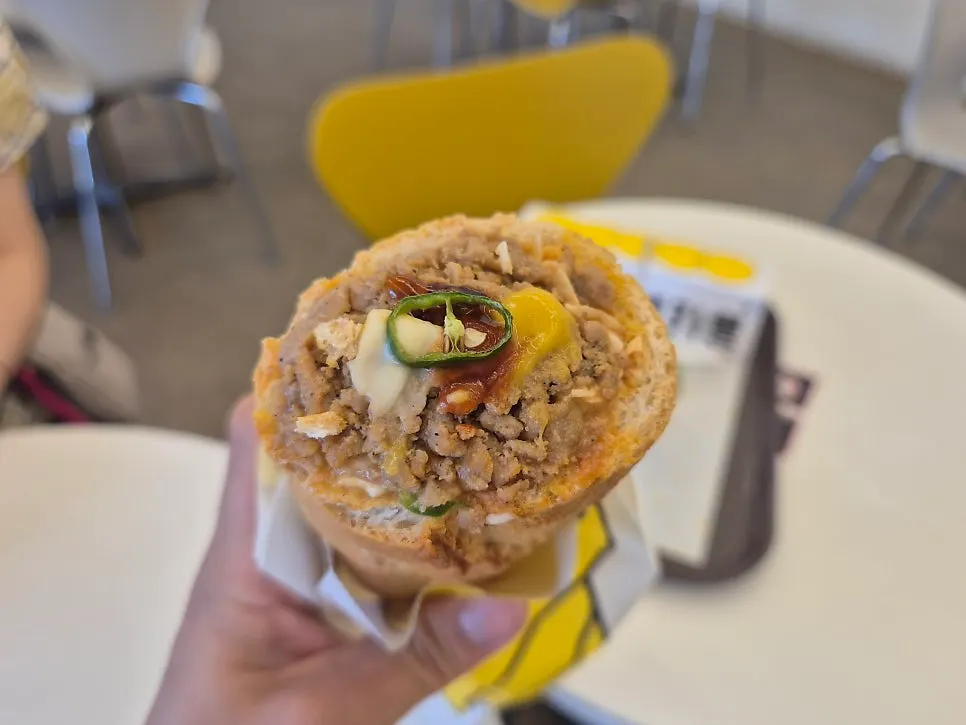 Cross-section of the baguette burger filled with meat and vegetables