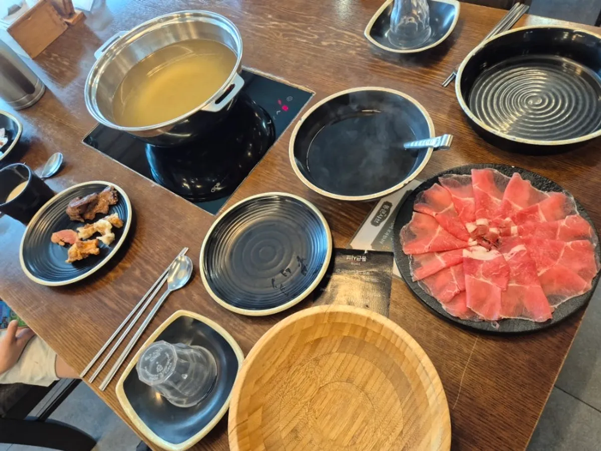Family table set up for a meal at Tongkeun Shabu