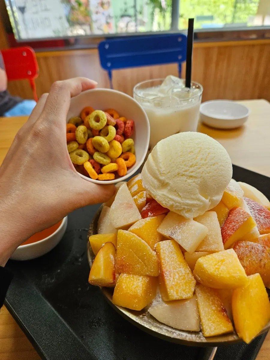 A spoonful scooped from the peach bingsu