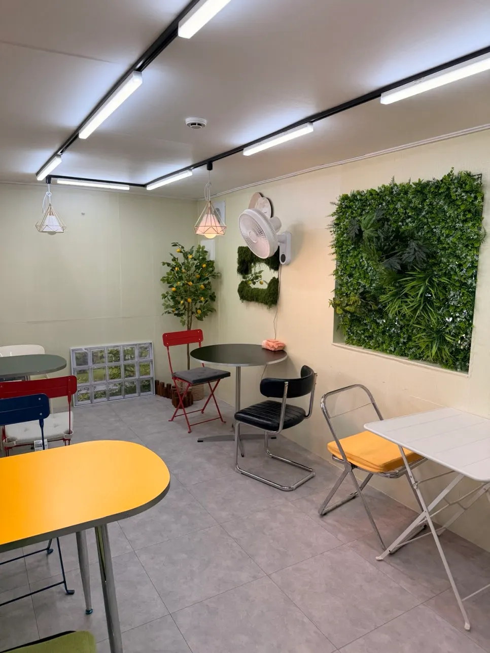 Indoor seating with round tables and colorful chairs