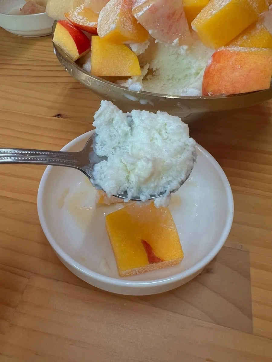 Peach bingsu topped with ice cream