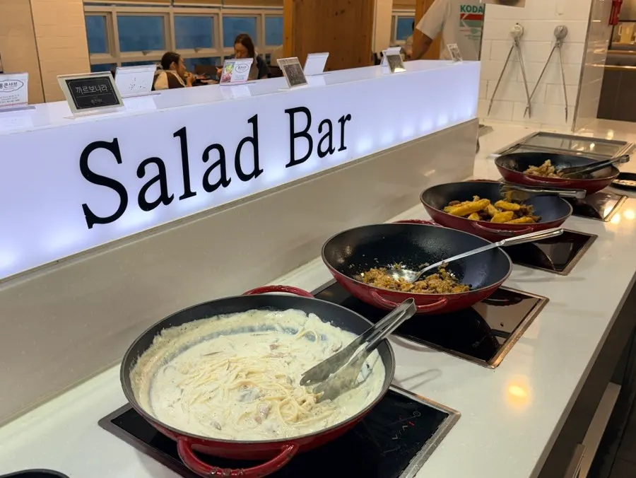 Spaghetti and fried items plated from the salad bar