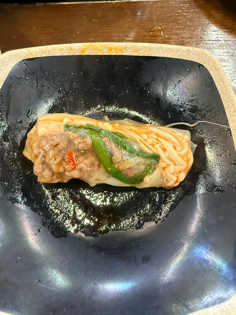 A bowl with shabu-shabu meat and vegetables scooped out
