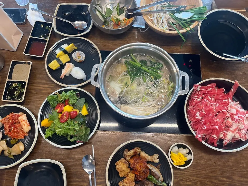 A plate with chicken, mala dakgangjeong, and mango salad