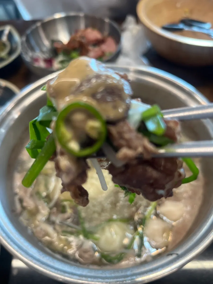 Table setting with shabu-shabu pot and vegetables