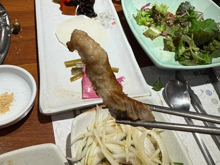 Grilled pork neck eaten with salted shrimp sauce
