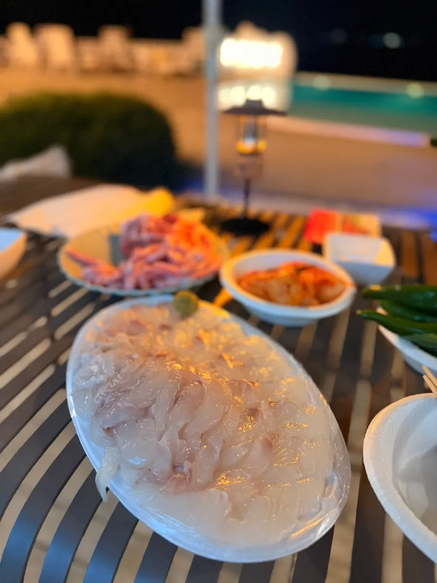Plate of firm, vividly colored wild flounder sashimi