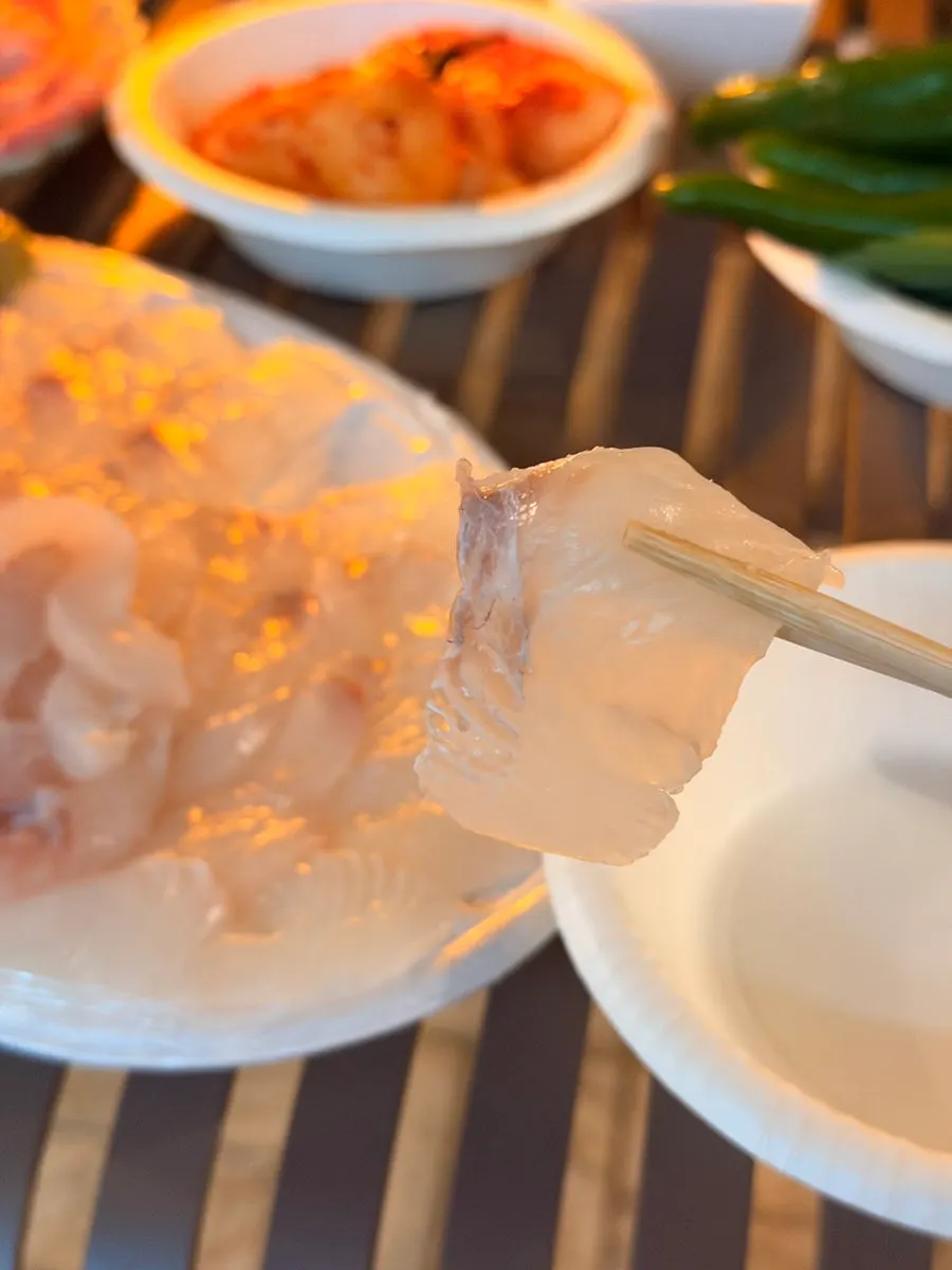 Flounder sashimi wrapped in a lettuce leaf